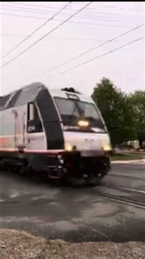 NJT ALP Multi Level car and cab car passenger train passing.