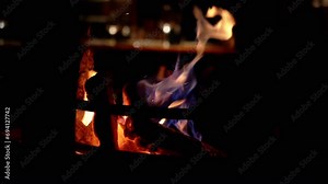 Fireplace in an Empty Cozy luxury Restaurant with Serving Tables. Interior. Burning wood fireplace. Warm light. Nobody. Romantic candlelight dinner in an intimate setting. Relax atmosphere. Evening.