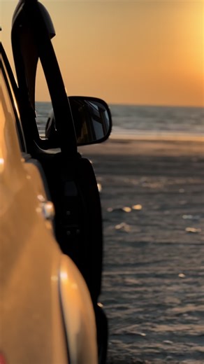 Man in Traditional Attire Walks Along Serene Beach