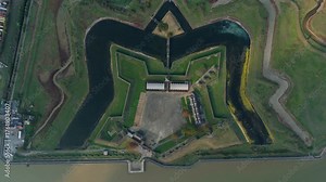 Top down aerial drone view of Tilbury fort on the River Thames near London. interesting shape with walls and moat and draw bridge and seawall. WW2 defence structure