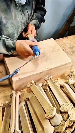 Craftsman shaping wood with rotary tool, detailed precision