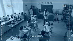 High angle camera shot of African American male teacher lecturing to elementary school children during 3D modelling class in modern school