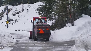 Sweeper removing snow from a road - Free Stock Video