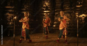 Enchanting Dynamic Shot Showcasing a Lively Ensemble of Indian Women Joyfully Dancing Traditional Folk Inside an Empty Historic Temple. Vibrant and Mesmerizing South Asian Cultural Festivity