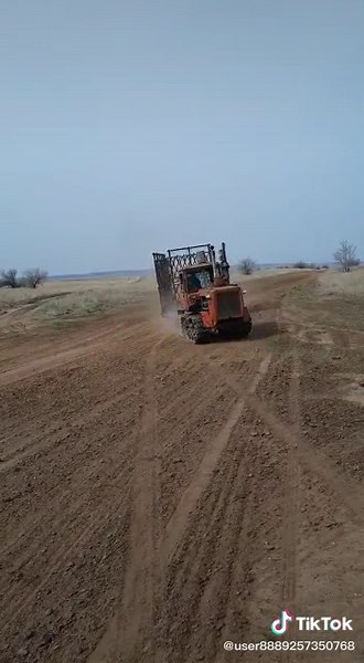 Orange Tractor Working in Rural Field