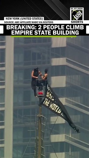 BREAKING: Two people climb to the top of New York's Empire State Building, unfurl peace banner