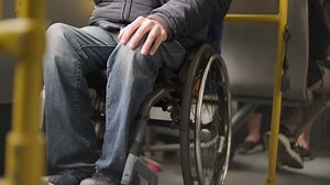 Person with a physical disability inside public transport with an accessible ramp