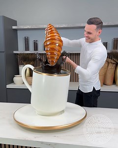 9.2M views · 258K reactions | Step into my world of chocolate artistry as I create a gigantic espresso cup, crafted entirely from chocolate and paired with a giant handmade croissant. This project is the ultimate tribute to the perfect breakfast, where every element is not only a visual feast but also completely edible. Watch as I bring these breakfast staples to life in a way you've never seen before. Who wants to share this for breakfast? | Amaury Guichon | Facebook