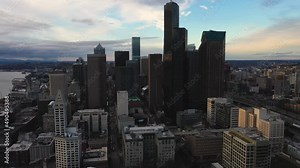 Rising drone shot of Seattle's downtown skyscrapers highlighting Smith Tower and Columbia Tower.