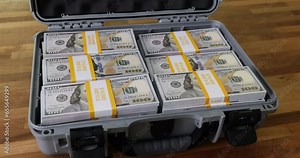 Lock with numbers on dollars in suitcase closeup. Code lock and safe storage of money