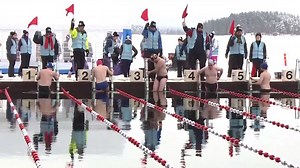 Swimmers Brave Freezing Temperatures to Take a Dip in Icy Lake