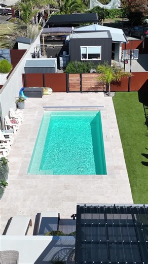 Mapua Tasman Sanctuary: The Ultimate Backyard Retreat Compass Pools NZ Sanctuary 8.2 in Pearl, transforms this backyard with its modern geometric design. It features a full-length bench and steps for family fun and relaxation, an unobstructed swimming corridor, and clean lines to complement contemporary spaces. The Vantage Self-Cleaning Circulation System ensures pristine water quality. With easy entry from both ends and a non-slip finish, it's the perfect blend of style, safety, and functionali