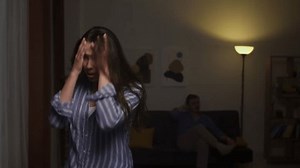 Emotional Anguish and Physical Struggle: Young Woman Reacts to Betrayal as Man Seeks to Calm Tense Situation at Home