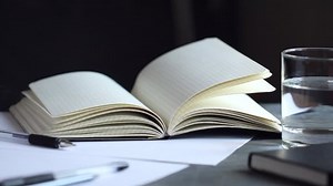 clip-1009461917-view-workplace-open-notebook-over-table