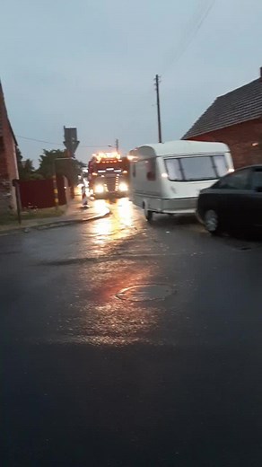 Large Trucks Navigating Wet Roads at Dusk