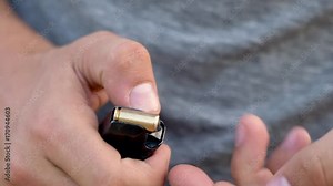 Loading ammo magazine. Close up of male hand loads magazine with bullets Stock Video