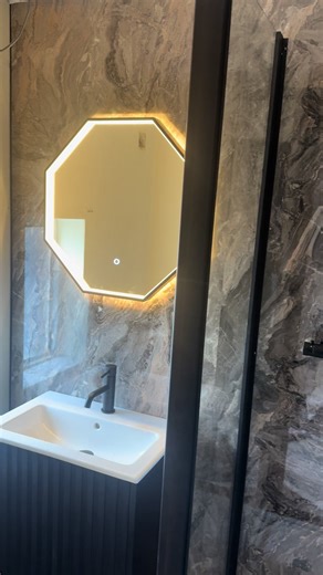 🚿 ✨ Our customer was experiencing leaks in their existing cubicle, so we designed and installed a completely new solution. We removed all the old tiles and plasterboard, replacing them with moisture-resistant boards to ensure long-lasting durability. We transformed the space with a brand-new design. ✨ Cappuccino stone walls ✨ Fluted basin unit ✨ Black bi-folding shower enclosure ✨ Twin outlet shower with drencher & handset ✨ Matte black taps & fixtures ✨ Passa LED Mirror Light A sleek, modern u