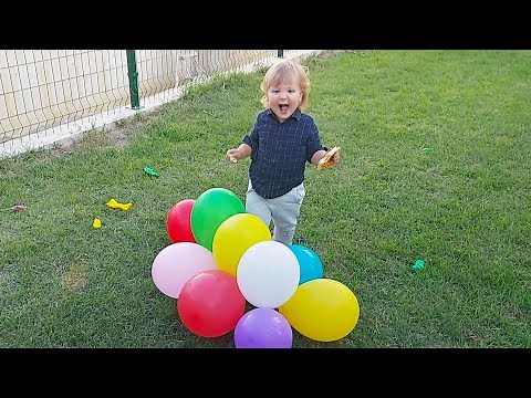 Cute Baby Playing with Party Balloons and Laughing