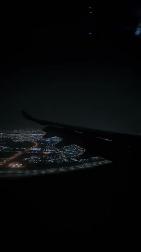 Nighttime Airplane Window View of City Lights