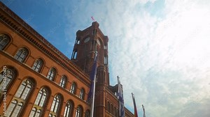 The towering Rotes Rathaus, Berlin’s iconic red city hall, under a partly cloudy sky, representing the city’s architectural and historical significance