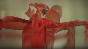 Art dance moves with long fabrics . Few shots of the powerful psychological contemporary ballet dancing movements with large textile materials . People dancing , flying , jumping . Growth of cloth