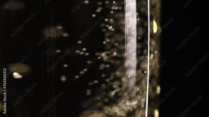 Glass of champagne on a black isolated background. Capturing the effervescence: Slow-motion, super macro shot showcasing delicate champagne bubbles gracefully rising in an elegant glass against a pris
