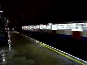 Two Metropolitan Line trains passing through Kilburn station
