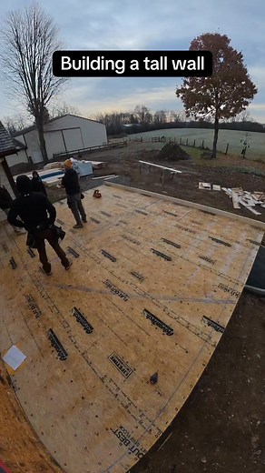 Building this great room tall wall with 6 windows in it. #construction #carpenter #wood #tall | Mueller Construction