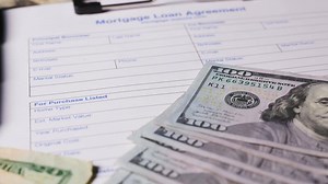 Mortgage Loan Agreement form document with US dollar bills
