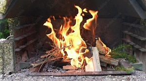 Methylated spirits are poured into the small fire in the charcoal grill and the flames immediately become larger. Dangerous fire Stock Video