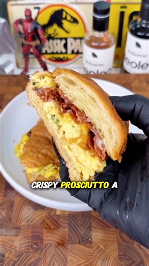 The best breakfast sandwich you’ll ever taste. Scrambled eggs, melty white cheddar, salty prosciutto, sweet caramelized onions, and a drizzle of peach sauce that ties it all together. Pure morning magic. 🍳✨ #breakfastgoals #foodie #yum #brunchvibes #breakfastsandwich #eggsandcheese #prosciutto #peachsauce | Ryan Tyler Cooks