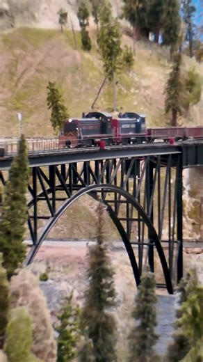Two Southern Pacific end-cabs cross our O scale high bridge at GSMRM