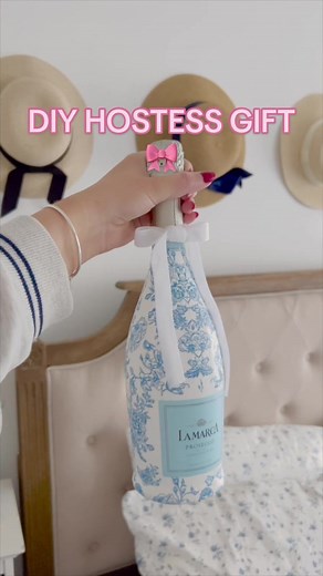Bookmark this DIY idea 🔖 Custom wine bottle handcrafted for that gal pal, hostess, or wino in your life 🍷 Simply paint on a design or decoupage paper napkins to it with mod podge! Also, don’t forget to add a bow! Cheers ✨ #giftguide #hostgiftideas #hostessgift #paintedwinebottle #decoupage #blueandwhite #blueandwhiteforever #grandmillennial #grandmillennialstyle #toile #toiledejouy #preppy Painted wine bottle, decoupage wine bottle, hostess gift idea, holiday gift idea
