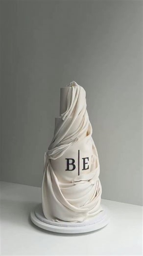 Inspired by sculptural drapery — the movement of fabric frozen in a quiet moment. Soft yet powerful, | K CAKE