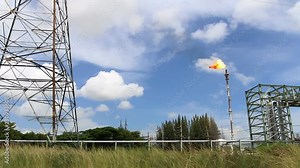 Fire on flare stack at oil and gas central processing platform release over pressure from process. Petroleum refinery plant