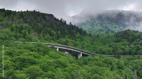 Blue Ridge Parkway road trip. Linn Cove Viaduct driving. Car exploration travel in summer forest on Appalachian mountain hills in North Carolina. Summertime landscape of beautiful nature