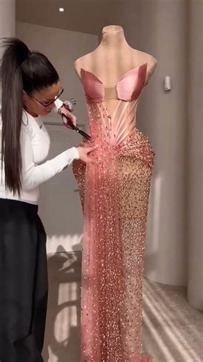 Share with a friend who would own the spotlight in this blush sculptural corset gown! To order, send