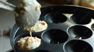 Appam or Mixed dal or Rava Appe South Indian dish preparation on iron pan