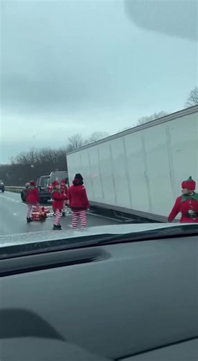 Santa Arrested After Semi Loaded With Presents Spills Across Highway in Bizarre Holiday Traffic Jam I-94, Michigan — December 4, 2025 Drivers along I-94 experienced one of the most surreal traffic delays of the season when a semi-truck loaded to the roof with wrapped Christmas presents tipped onto its side, scattering hundreds of brightly colored gifts across the icy roadway. But the strangest sight wasn’t the presents—it was the team of elves scrambling to collect them, and a man dressed as San