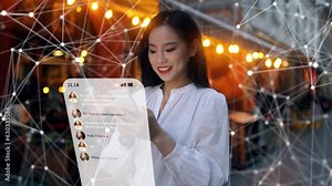 Beautiful Smiling Asian Woman Using Phone on a City Street at Night. Visualization of Social Media, Chatting, Texting, Messaging App Icons Flying Around the Phone. Social Networking Service