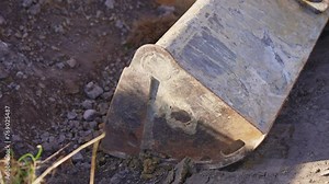 A tractor digs a hole at a construction site. Working process at a construction site. Tractor bucket close up. High quality 4k footage Stock Video