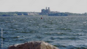 Pulp mill factory on the other side of a large body of water, on a windy summer day