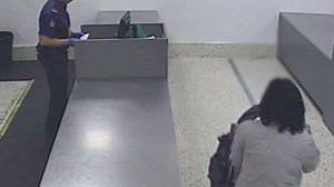 Australian Customs and Border Protection officers pull Kay Smith aside at Melbourne Airport to inspect her luggage.