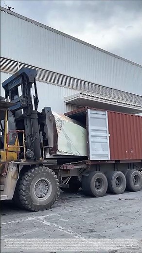 The process of unloading marble from a truck using a forklift.