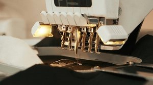 The automatic embroidery machine is working at high speed. Close-up