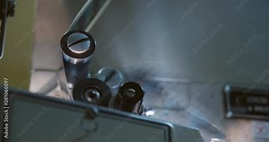 The movement of the cine-film through the tape path. Clamping guide rollers and gear drums. Close-up.