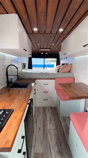 Would you buy this 2021 Mercedes Sprinter Van 4x4 for over $100,000? Van prices are crazy these days, but this one sure is a nice conversion! Inside, there's a small kitchen, a dining nook for 2, a full-size bed in the back with storage underneath, a pull-out toilet (not shown), a swivel passenger seat, an outdoor shower, and tons of built-in storage throughout! Built by Live More Camper Vans 🚐 #vanlife #vanconversion #vanlifers #vanlifestyle #campervan | Dream Big Live Tiny Co.