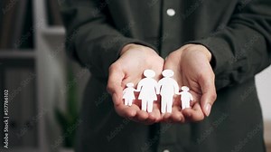 Family protection concept. Hands with cut out paper silhouette Family care concept. In hands of family cut out of paper. Family day concept, domestic violence, home schooling, international family day