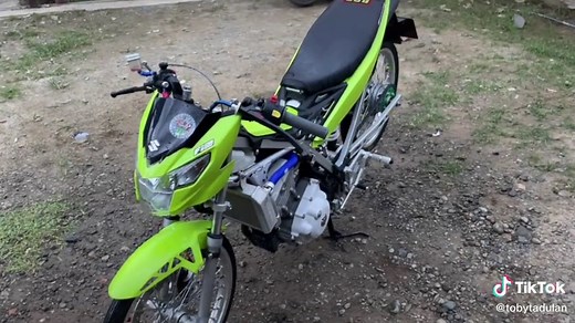 Stationary Green and Black Motorcycle with License Plate 999