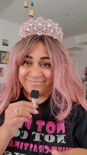 Person with Pink Hair and Tiara Performs on Stage